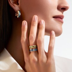 A Woman Wearing Rings And An Earring